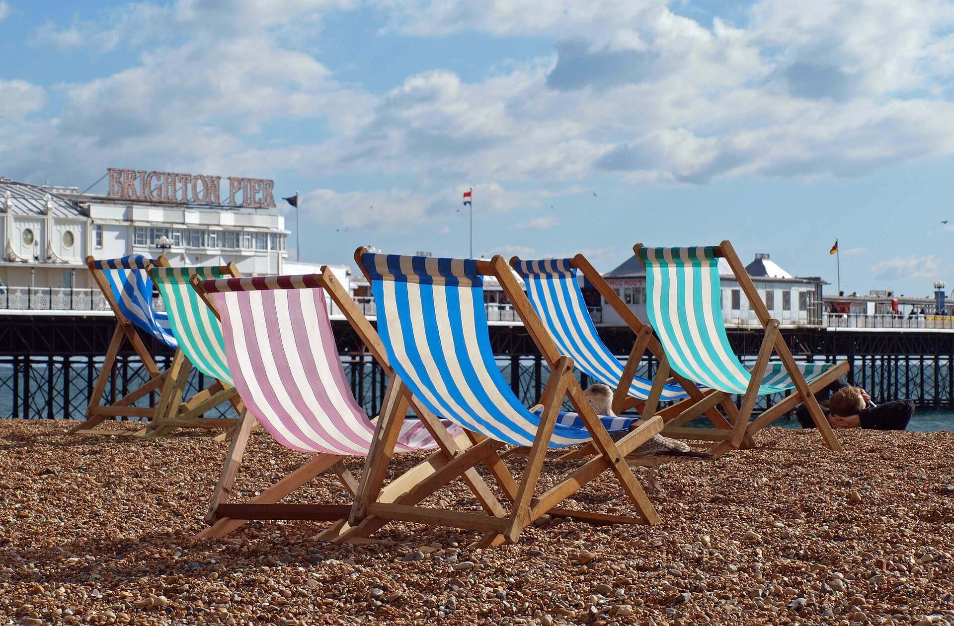 Multi-coloured deck chairs with Brighton Pier in the background